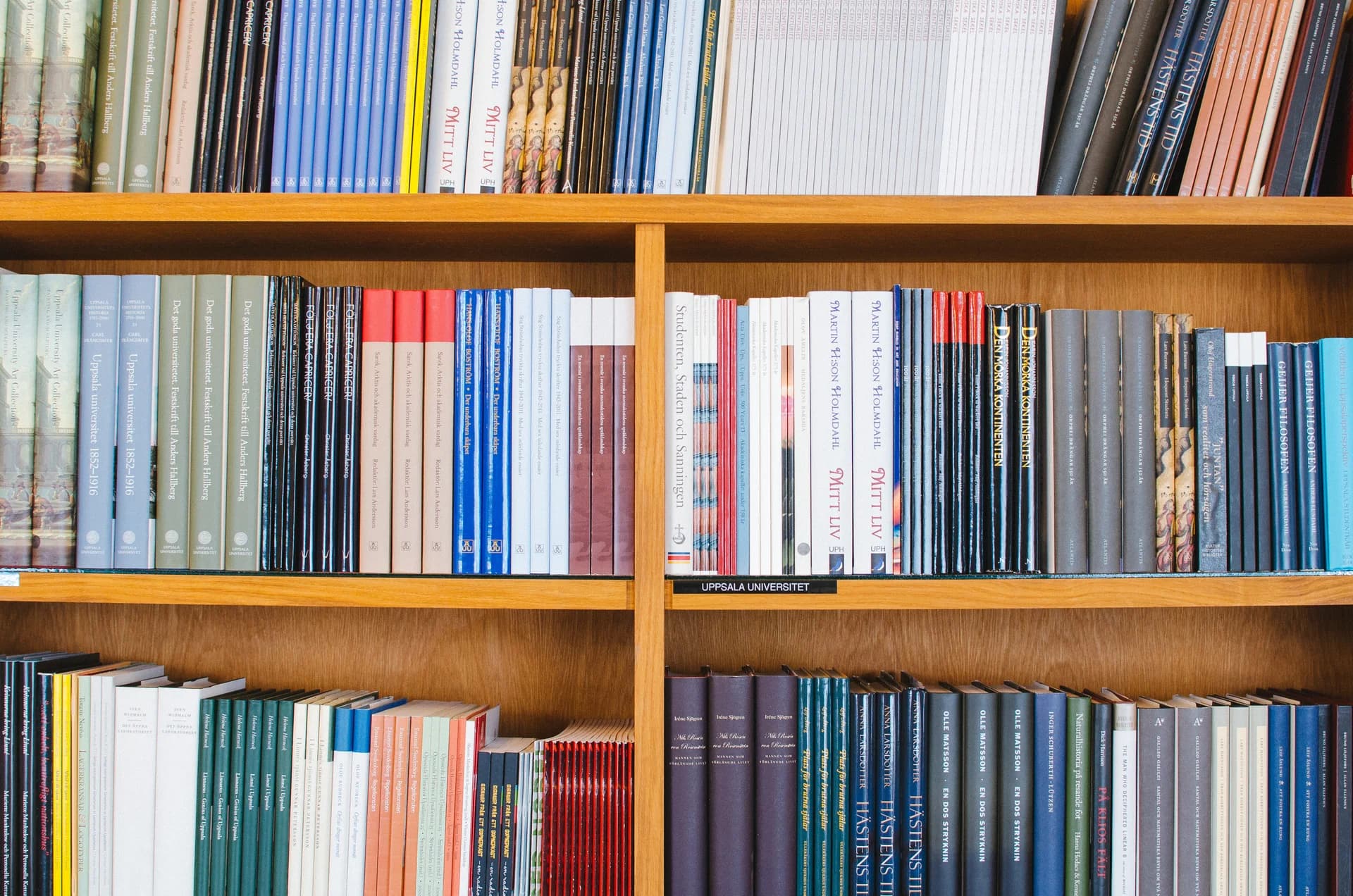 Colourful books arranged on library shelves in Uppsala