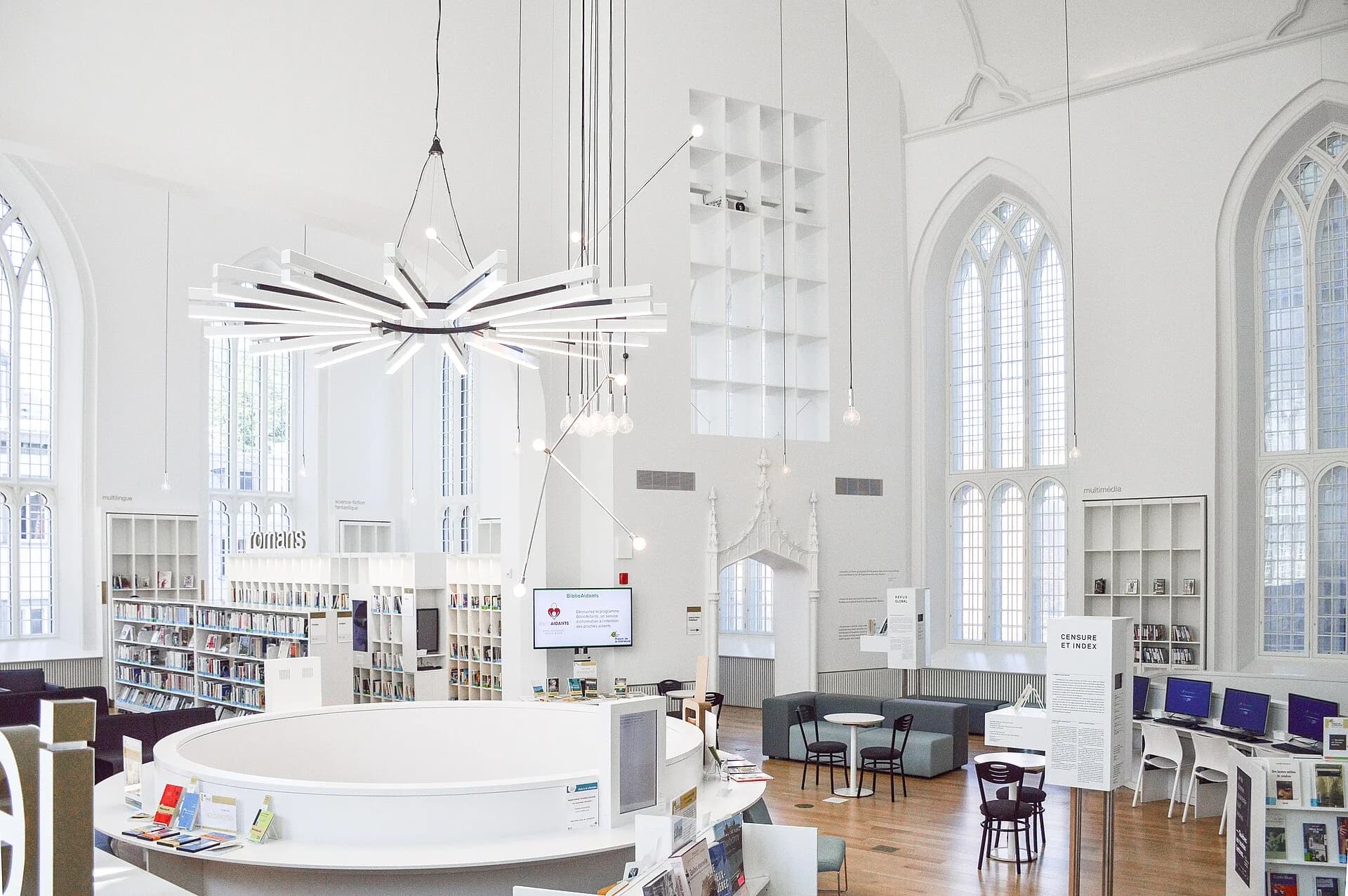Tall windows and reading tables in a bright library in Québec City