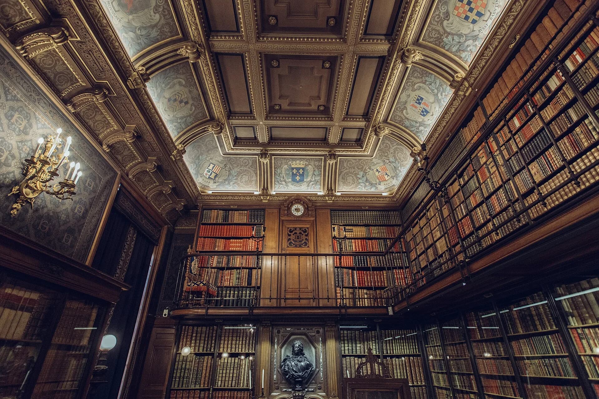 Bookshelves and a decorated ceiling in the library at Chantilly, France